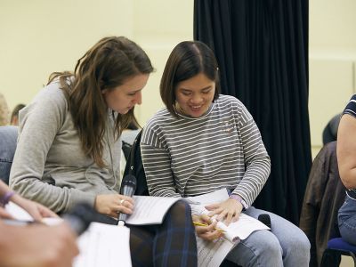 students looking over notebook
